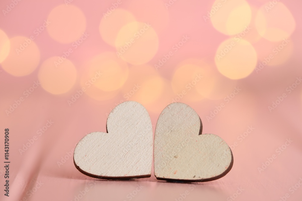 White hearts on wooden table against festive lights, space for text. St. Valentine's day White hearts on wooden table against festive lights, space for text. St. Valentine's day