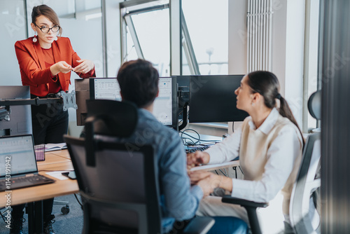 Employees engage in a collaborative discussion within a modern office. The scene highlights teamwork, communication, and the multicultural work environment, fostering innovation and understanding. photo