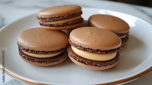 Delicious chocolate French macarons arranged on a plate showcasing their delicate texture and delightful filling.