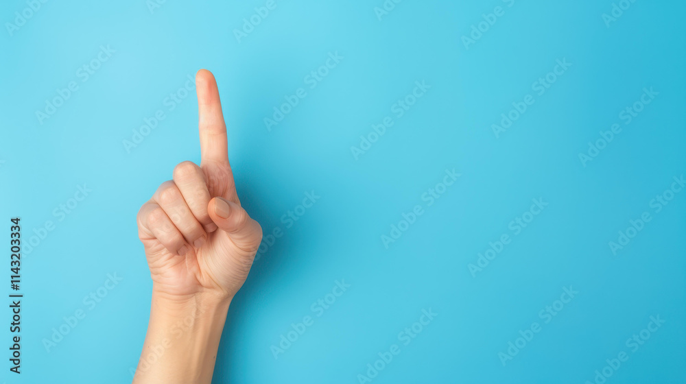 A female hand elegantly displaying the number one, with an index finger pointed upwards against a light blue backdrop. A female hand elegantly displaying the number one, with an index finger pointed upwards against a light blue backdrop.