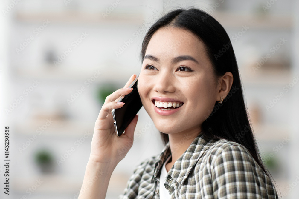 Pretty young asian woman chilling on couch at home, talking on cellphone, smiling and looking at copy space, closeup portrait. Happy chinese lady having phone conversation with girlfriend or lover Pretty young asian woman chilling on couch at home, talking on cellphone, smiling and looking at copy space, closeup portrait. Happy chinese lady having phone conversation with girlfriend or lover