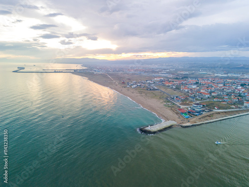 Karasu Aerial View of Coastal Town with Harbor and Beach at Sunset. High-angle, full shot of a coastal town, harbor, and beach at sunset. Sakarya Adapazari Turkiye Turkey Drone shot sunrise photo