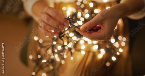 Close-Up of Untangling Christmas Lights by Woman in Home Comfort