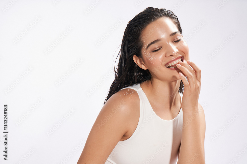 Joyful woman with water droplets on face, studio portrait Joyful woman with water droplets on face, studio portrait