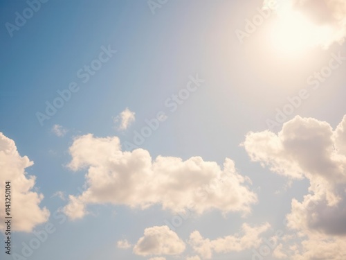 Fluffy white clouds floating in a clear blue sky on a sunny summer day, nature, sky
