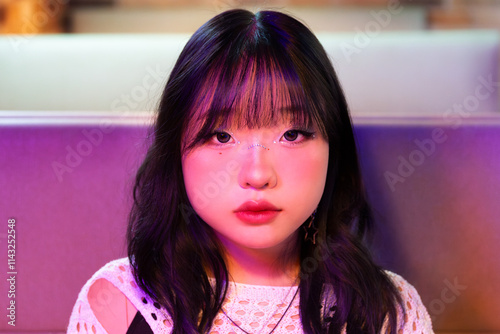 Asian Gen Z Girl Enjoying Vibrant Arcade Atmosphere photo