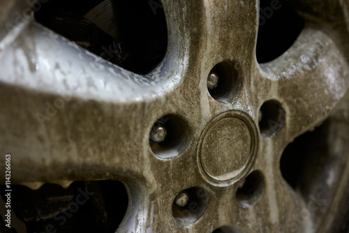 Closeup shot depicting a Dirty Car Wheel that is covered with Mud and Grime buildup