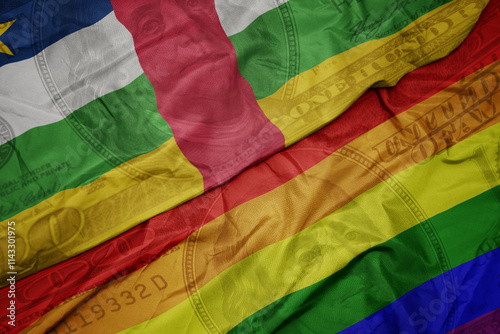 waving colorful flag of central african republic and gay rainbow flag on the dollar money background. finance concept. photo