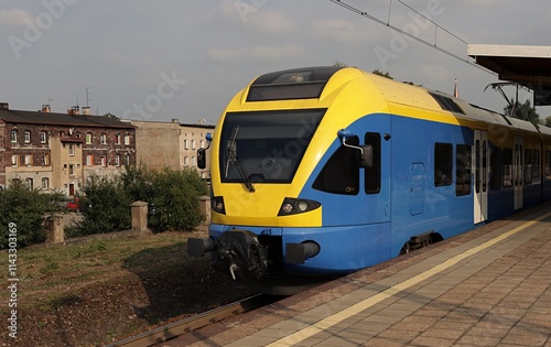 Passenger train standing at a railway station.