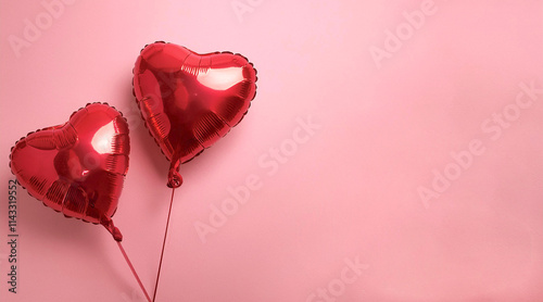 Red heart-shaped balloons isolated on a pink background