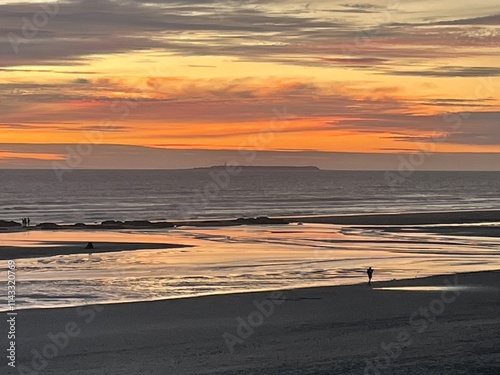 Sunset over the pacific with distant walkers
