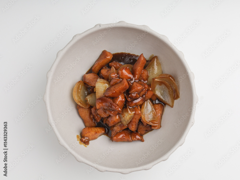 Chicken cooked in teriyaki sauce with onion in a bowl Chicken cooked in teriyaki sauce with onion in a bowl