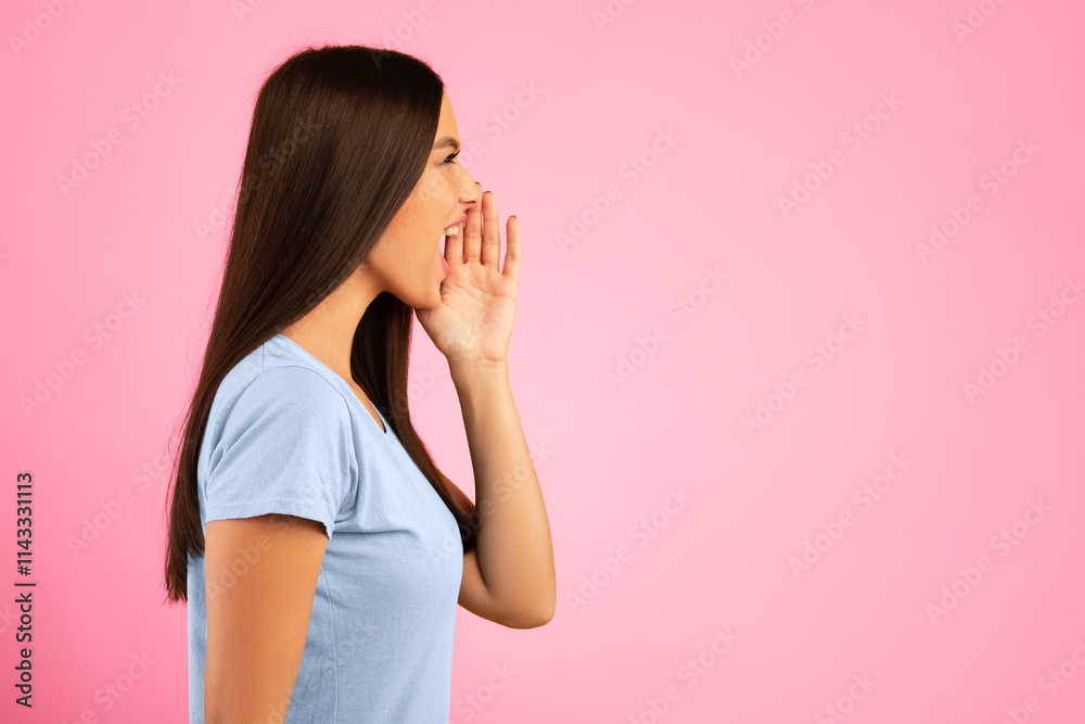 Making Announcement. Closeup side view portrait of emotinal woman shouting and holding palm near mouth. Female model screaming important information at copy space isolated on yellow studio background Making Announcement. Closeup side view portrait of emotinal woman shouting and holding palm near mouth. Female model screaming important information at copy space isolated on yellow studio background