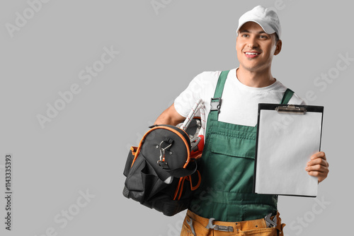 Smiling young repairman hol...