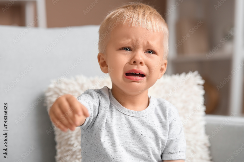 Cute baby boy crying at home, closeup
