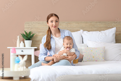 Happy young mother holding ...