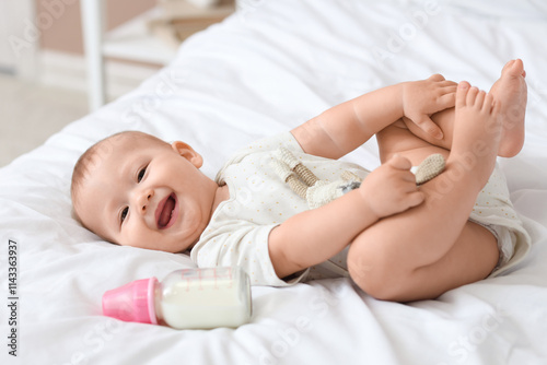 Cute baby with toy and bott...