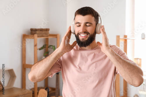 Young bearded man in headph...