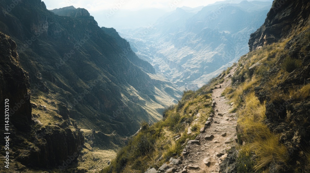 Narrow Trail Overlooking Deep Valley in Mountain Landscape Narrow Trail Overlooking Deep Valley in Mountain Landscape