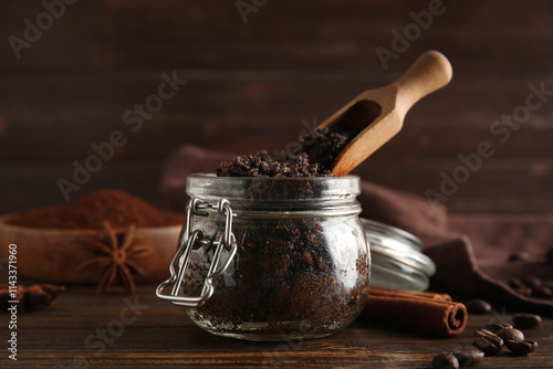 Jar with coffee body scrub on wooden background photo