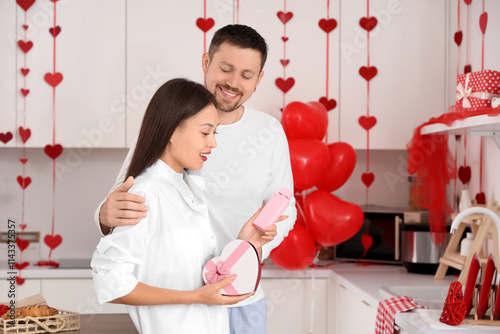 Young Asian woman with gift...