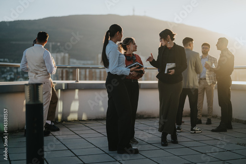 A group of diverse and multiracial business colleagues are engaged in a brainstorming session on a high tower balcony during sunset, fostering creative and collaborative discussions.