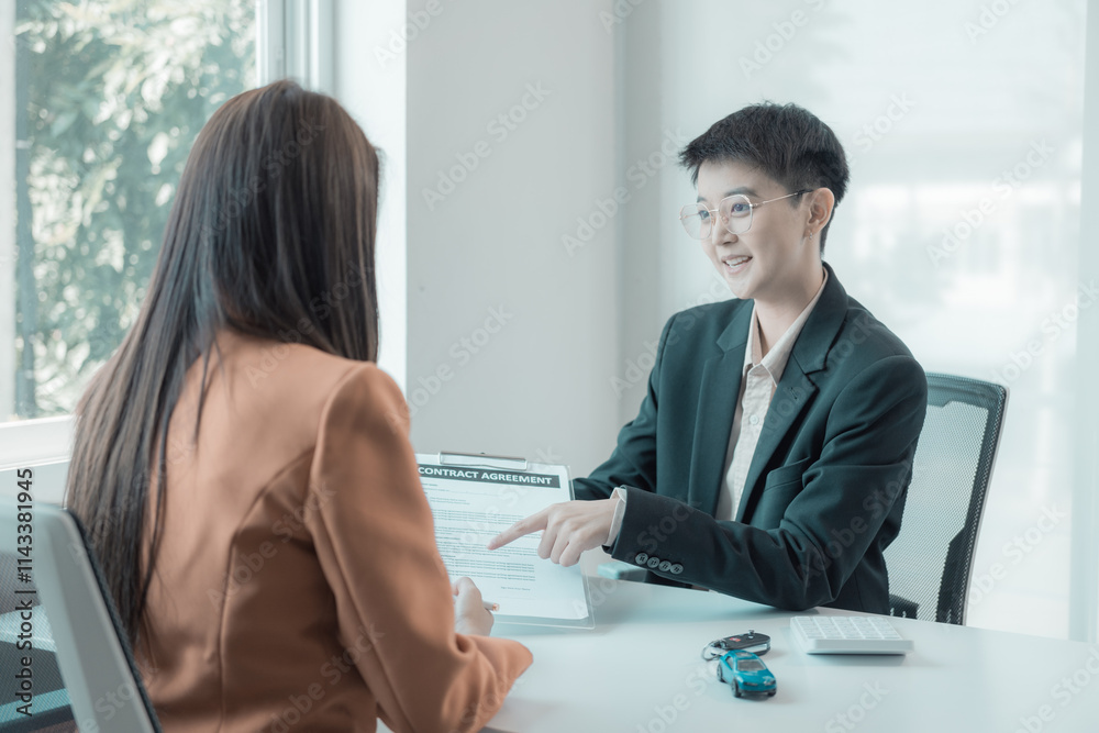 Car insurance salesman introduces customer to table with small car and car keys, sales concept, accident insurance, car dealership Car insurance salesman introduces customer to table with small car and car keys, sales concept, accident insurance, car dealership
