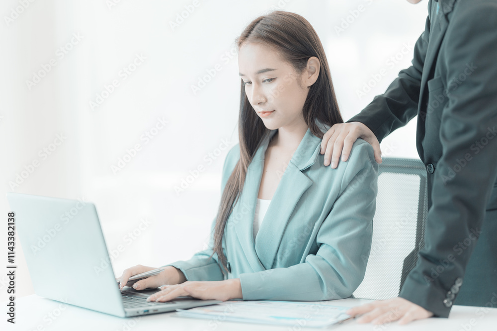 The female employee is uncomfortable. Look at the hand of your boss or male co-worker as they touch your shoulder and embrace. inappropriate sexual harassment The female employee is uncomfortable. Look at the hand of your boss or male co-worker as they touch your shoulder and embrace. inappropriate sexual harassment