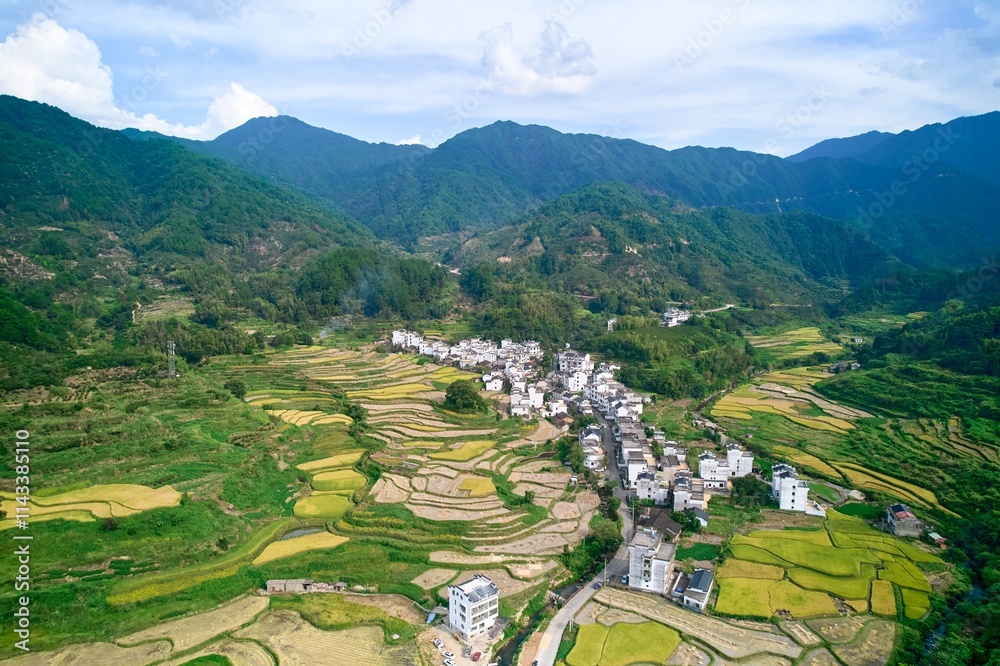 Breathtaking aerial view of rural Wuyuan countryside showcasing terraced fields and quaint village life under blue skies Breathtaking aerial view of rural Wuyuan countryside showcasing terraced fields and quaint village life under blue skies
