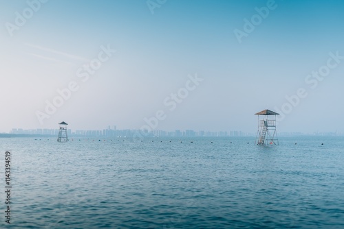 Relaxing view of Beidaihe Pigeonhole Scenic Spot during summer near the water with distant city skyline photo