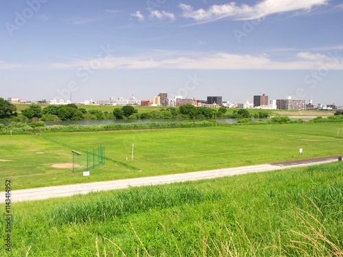 初夏の土手から見る野球場のある江戸川河川敷風景 photo