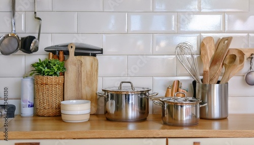 Countertop with knives, pots, cutting board and various ingredients organized in kitchen