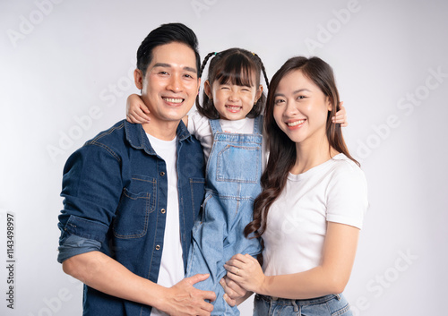 portrait  of a happy asian  family posing on a white background photo