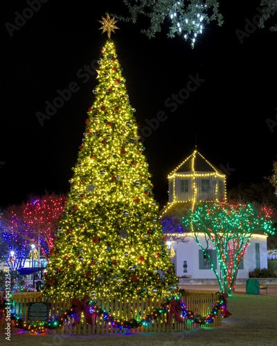 Fredericksburg, Texas lights up their Market Platz to display their historic small town German culture with an ice rink, decorated Christmas tree and the larger than life wooden Christmas pyramid. photo