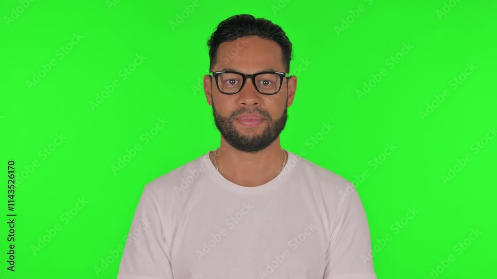 Man Shaking Head in Acceptance on Green Background Man Shaking Head in Acceptance on Green Background