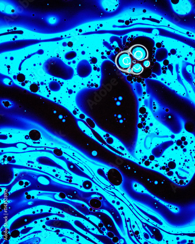 Flowing patterns of abstract blue and black liquid