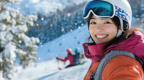 Japanese woman snowboarding with helmet and goggles at slope snow mountain