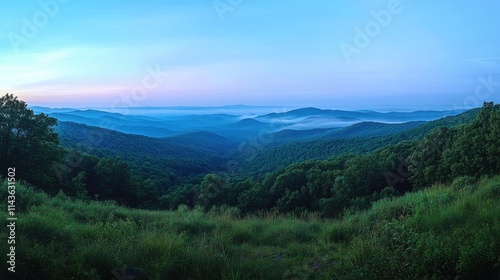 Panoramic mountain landscape layers of blue tinted ridges