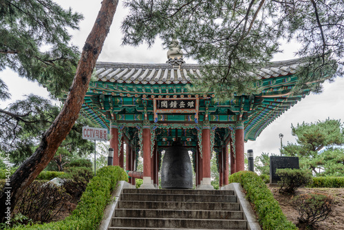 A ceremonial bell ringing in the New Year, housed in a traditional bell pavilion, symbolizing new beginnings and harmony. photo