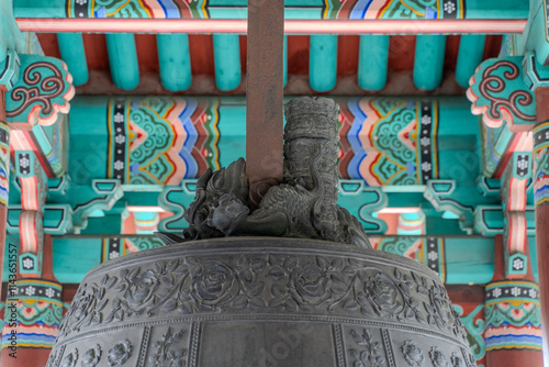 A ceremonial bell ringing in the New Year, housed in a traditional bell pavilion, symbolizing new beginnings and harmony. photo