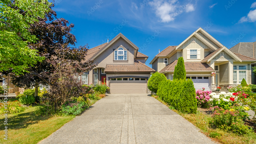 Garage door in luxury house with trees and nice landscape in Summer in Vancouver, Canada, North America. Day time on June 2024. Garage door in luxury house with trees and nice landscape in Summer in Vancouver, Canada, North America. Day time on June 2024.