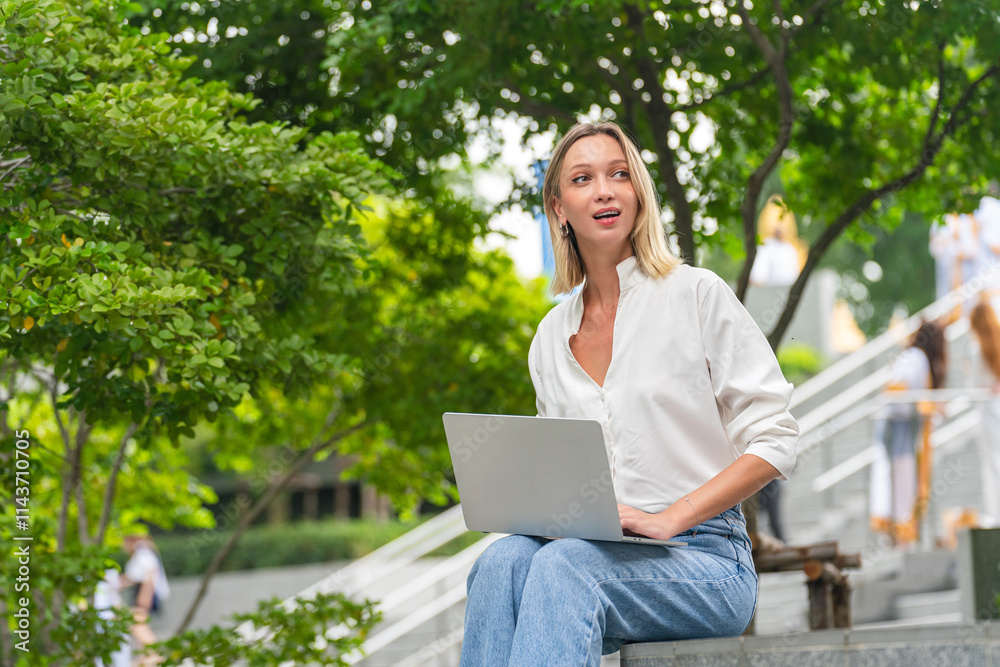 Caucasian Woman Using Laptop to Work While Sitting Outdoor a Park Caucasian Woman Using Laptop to Work While Sitting Outdoor a Park