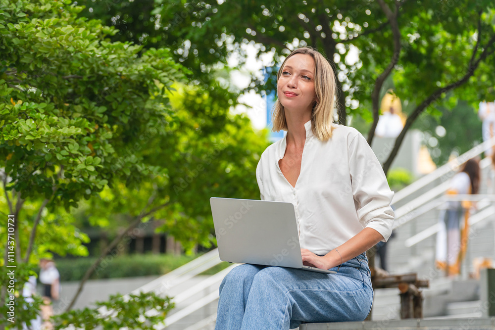 Caucasian Woman Using Laptop to Work While Sitting Outdoor a Park Caucasian Woman Using Laptop to Work While Sitting Outdoor a Park