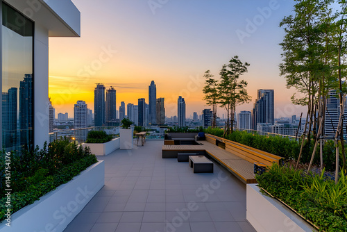 Modern rooftop terrace overlooking city skyline at sunset photo