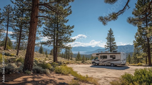 A spacious motorhome parked under towering pine trees with mountains in the background on a sunny day