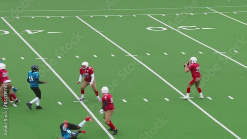 Dynamic American Football Game with Diverse Male Athletes in Red and Blue Jerseys. Players Tackle for the Ball, Executing Strategic Plays. Team Celebrating When Scoring Points