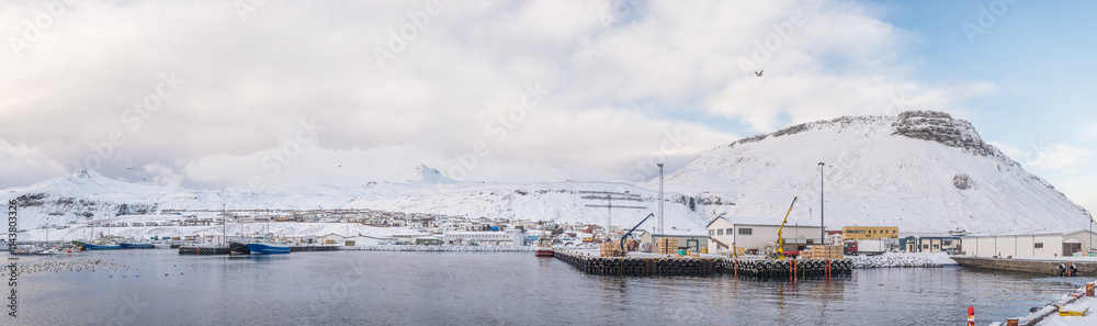 Fototapeta premium Panoramic snowy fishing town by the water