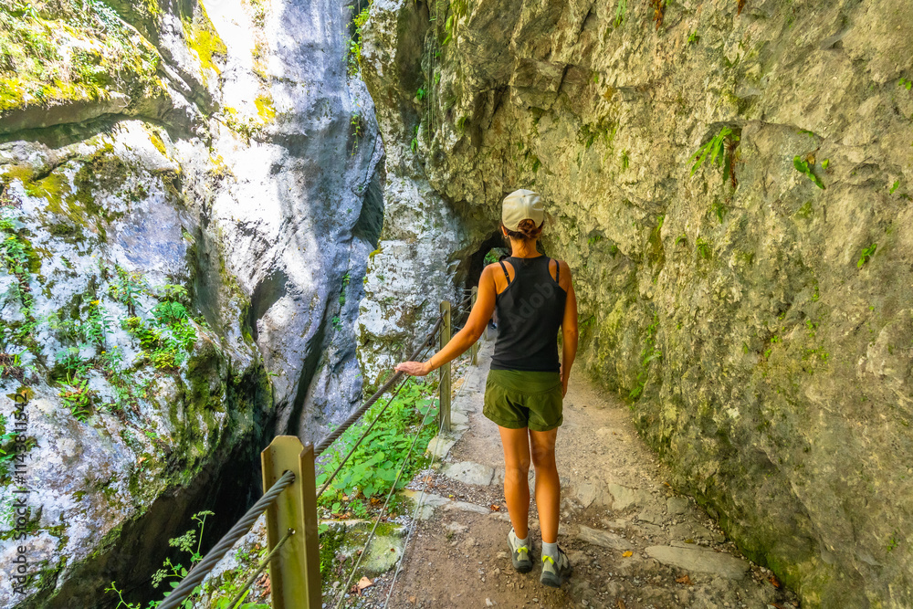 Fototapeta premium Tourist walking in tolmin gorges in slovenia during summer