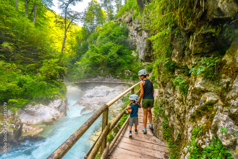 Tourists walking on wooden footbridge over radovna river in vintgar gorge, slovenia Tourists walking on wooden footbridge over radovna river in vintgar gorge, slovenia