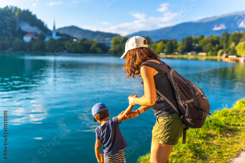 Mother and son enjoying summer vacation at lake bled, slovenia